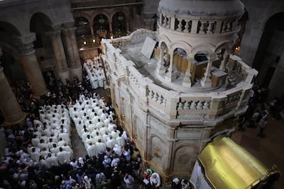 Catholic clergymen hold prayers next to the Edicule, the chamber said to house the tomb of Jesus. EPA