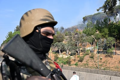 A Lebanese soldier stands guard next to flames and smoke following a reported Israeli airstrike in the town of Kahaleh on Wednesday. The Biden administration could take important steps to improve its policies in the Middle East, but it needs to be realistic about what can be done. EPA