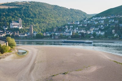A cargo ship passes an exposed sandbar on the Rhine. Getty Images