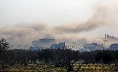 Smoke billows above buildings after an air strike by pro-regime forces on the village of Nayrab, about 14 kilometres south-east of the city of Idlib on February 25. AFP