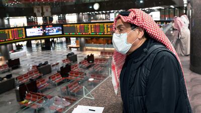 A Kuwaiti trader wears a protective face mask, following the outbreak of the new coronavirus. Trading was suspended last week in the country's premier market after shares hit the maximum daily decline limit of 10%. Reuters