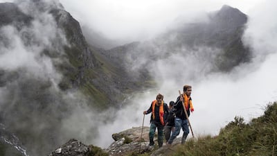 Devotees trek through the fog. Narendra Shrestha/EPA