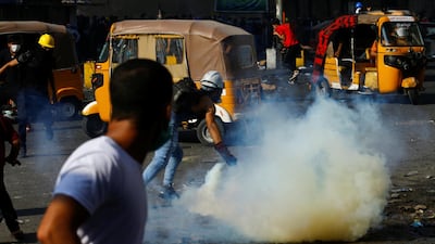 Iraqi demonstrators run away from tear gas thrown by Iraqi security forces during ongoing anti-government protests in Baghdad, Iraq. REUTERS
