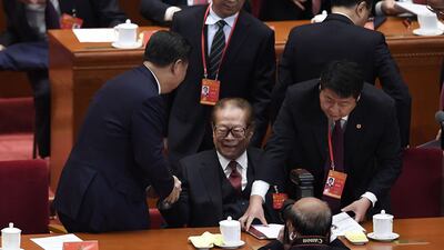 Chinese President Xi Jinping, left, greets China's former president Jiang Zemin at the opening session of the Chinese Communist Party's Congress in Beijing, October 18, 2017. AFP