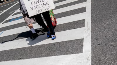 A person carries a sign protesting Covid-19 vaccines in Washington. AFP