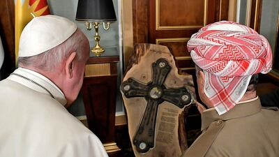 Pope Francis and the leader of the Kurdistan Democratic Party (KDP) Masud Barzani viewing a gift sculpture of a Chaldean cross during their meeting in Arbil, the capital of Iraq's northern autonomous Kurdish region. AFP
