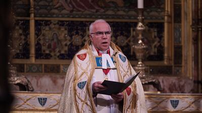 Dean of Westminster David Hoyle gives a reading during the service. PA