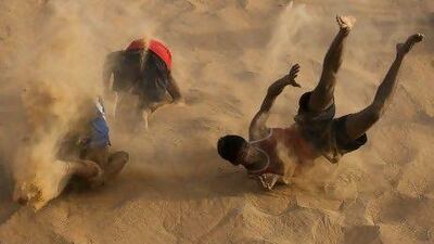The boxers roll back down the dune to start their climb back up. Andrew Caballero-Reynolds / AFP Photo