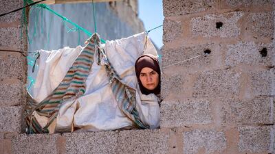 A Moroccan woman peeks out a window in the southern port city of Safi. AFP