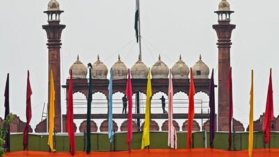The Red Fort adorned with colourful flags on the eve of India's Independence Day celebrations in the old quarters of Delhi. AFP