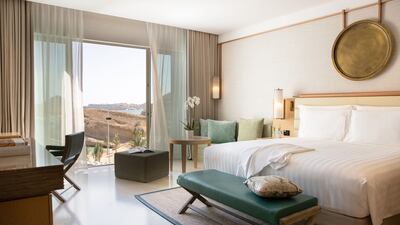 Rooms are decorated in a muted palette with subtle Arabesque accents