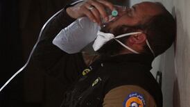 A civil defence member breathes through an oxygen mask after a toxic gas attack in Idlib, Syria, on April 4, 2017. Reuters