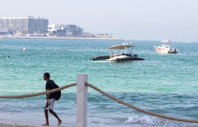 The partially sunken yacht in the waters off Jumeirah Beach Residence. Leslie Pableo for The National
