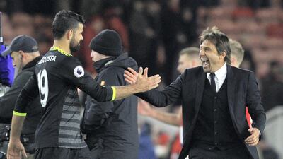 Diego Costa, left, and Chelsea manager Antonio Conte in happier times. The pair have fallen out and Costa is refusing to return to the club to train as he stays in Brazil. Lindsey Parnaby / AFP Photo