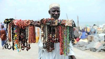 A vendor sells souvenirs at Bar Beach in Lagos. Akintunde Akinleye for The National