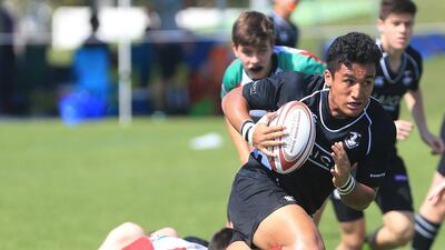England international Ugo Monye interacts with children during his visit to the Etihad Airways Abu Dhabi Harlequins Junior Rugby tournament at Zayed Sports City in Abu Dhabi on Saturday. Ravindranath K / The National