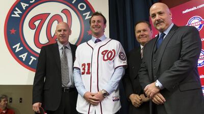 Washington Nationals pitcher Max Scherzer, second from left, poses for photographs during an introductory news conference at Nationals Park on January 21, 2015, in Washington. Scherzer signed a $210 million, seven- year contract to join the Nationals. Evan Vucci / AP Photo