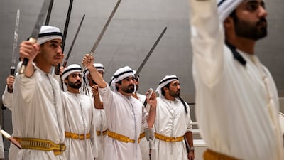 Performers participate during the inauguration of the Zayed National Museum