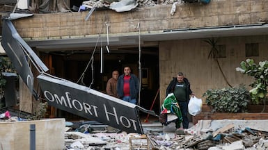 People leave the Comfort Hotel in Baabda, Lebanon after it was hit by an Israeli air strike. AFP