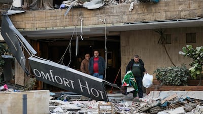 People leave the Comfort Hotel in Baabda, Lebanon after it was hit by an Israeli air strike. AFP