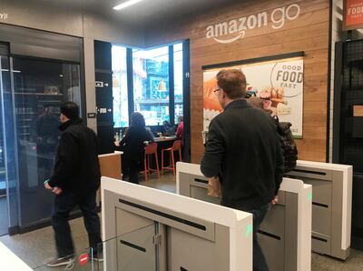 A customer walks out of an Amazon Go store in Seattle in the US without needing to pay at a cash register due to cameras and sensors that track goods that shoppers remove from shelves. Reuters