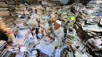 Abdallaa Abu Dawh, 82, a former teacher at Egypt's Al-Azhar university, reads in his basement home which contains about 15,000 books collected in the course of his life in the hope of offering young people in his village in the Nile Delta books to read for free. Reuters
