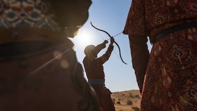 Baris Demirtas of Turkey demonstrates the form required to set up the bow and arrow for a long-distance shot