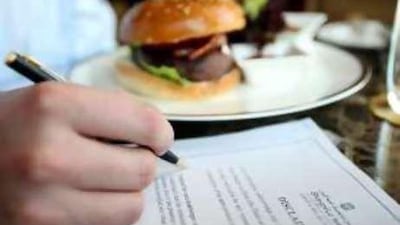 A diner signs a disclaimer for meat that is not cooked well-done at the Shangri-La, Abu Dhabi.