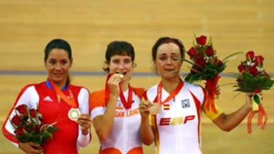 Left to right: silver medallist Yoanka Gonzalez of Cuba, left, gold medallist Marianne Vos of Netherlands, centre, and bronze medalist Leire Olaverria of Spain celebrate.
