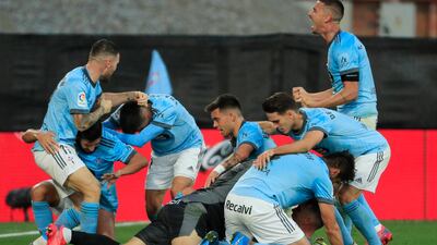 Celta Vigo's Iago Aspas, centre right, on ground, celebrates with team mates after scoring his side's third goal during a Spanish La Liga soccer match between Celta and Barcelona at the Balaidos stadium in Vigo, Spain, Saturday, Nov. 6, 2021. (AP Photo/Lalo R. Villar)