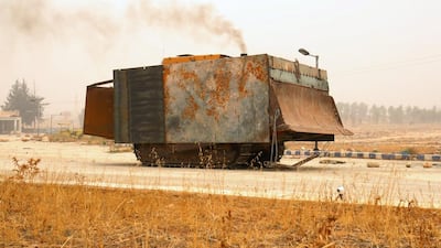 A makeshift military front loader drives in Dahiyat al-Assad, west Aleppo city, Syria, on October 28, 2016. Ammar Abdullah / Reuters