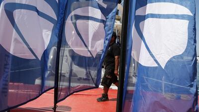 A man walks past banners from Absolute Yachts on display during the show. Antonie Robertson / The National