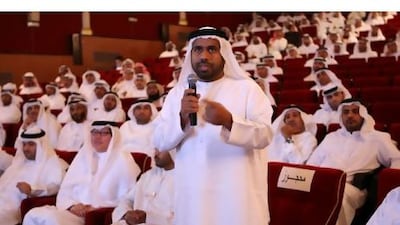 Musabeh Saeed Al Kilbi asks a question of Dr Saeed Al Ghafli, the assistant undersecretary of the Ministry of State for FNC Affairs, in Sharjah last night. Pawan Singh / The National
