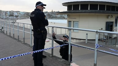 Police officers stand guard at Bondi Beach a day after Australia's worst mass shooting in decades. Reuters