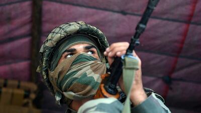 An Indian Border Security Force (BSF) soldier sits inside a truck upon arrival with others in Srinagar. Tauseef Mustafa / AFP