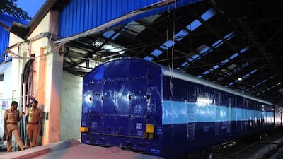 Indian police personnel stand guard alongside the Salem-Chennai Express train, which was robbed while in transit, at Egmore Railway station in Chennai. The equivalent of about US$750,000 was stolen from the moving train, police said. Arun Sankar / AFP Photo