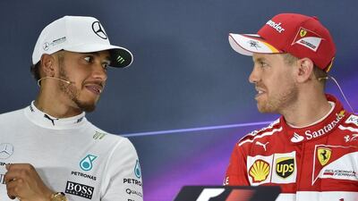 Ferrari's German driver Sebastian Vettel, right, winner of the 2017 Australian Grand Prix, and runner-up Lewis Hamilton, of Mercedes-GP, take part in a press conference after the Formula One race in Melbourne on March 26, 2017. Paul Crock / AFP
