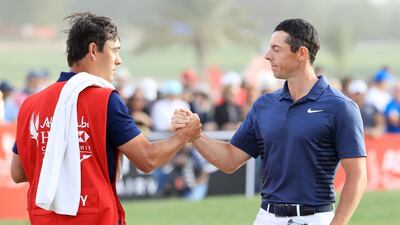 Rory McIlroy of Northern Ireland, right, and caddie Harry Diamond shake hands after finishing on the 18th green during the final round of the Abu Dhabi HSBC Championship at Abu Dhabi Golf Club. McIlroy finished tied for third place on 18-under. Andrew Redington / Getty Images