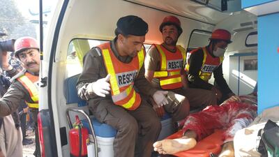 Rescue workers transport an injured person to hospital after gunmen attacked the Directorate of Agriculture Institute in Peshawar, Pakistan on December 1, 2017. Fayaz Aziz / Reuters