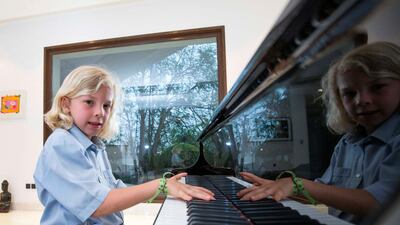 Claudius Tyacke, 7, first began playing piano two and a half years ago and won first prize in a competition at Conservatoire Slave de Musique music school last week. Leslie Pableo for The National