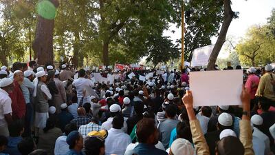 Demonstrators hold placards as they participate in a protest against the Citizenship Amendment Bill on December 15, 2019. AFP / SAM PANTHAKY