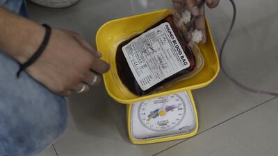 An Indian medical officer checks blood bags. The country is backing start-ups to battle the scourge of rampant untreatable bacterial infections. Shammi Mehra/AFP