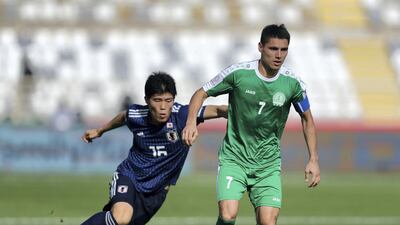 Tomiyasu Takehiro of Japan and Amanov Arslan of Turkmenistan tussle for the ball.