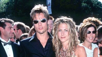 Brad Pitt, in a black suit and questionable sunglasses, and Jennifer Aniston at the 51st Annual primetime Emmy Awards in Los Angeles, California, on September 12, 1999. Getty Images