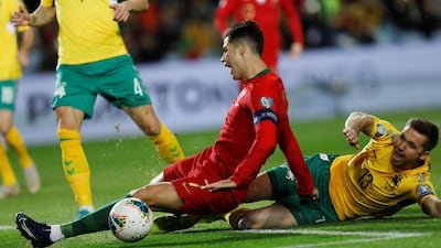 Cristiano Ronaldo is fouled by Lithuania's Saulius Mikoliunas, which resulted in a penalty. Reuters