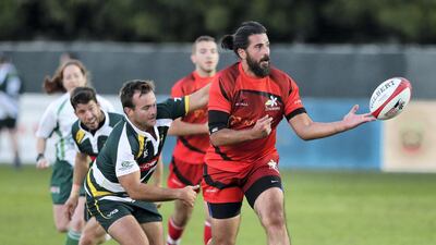 Nour Mardini, right, of Damascus Zenobians is tackled during the game against Riyadh Falcons at the Dubai Rugby Sevens. Chris Whiteoak / The National