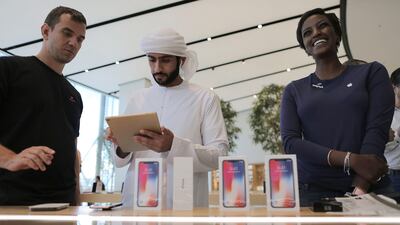 Customers look at the new iPhone X at Dubai Mall. Mahmoud Khaled / EPA
