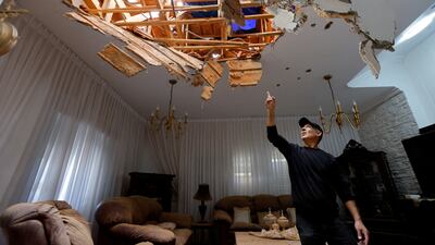 Haim Peretz, 60, points to damage to his house in Sderot, Israel, after a Hamas rocket strike. Reuters