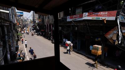 Workers carry goods at a market area in New Delhi.