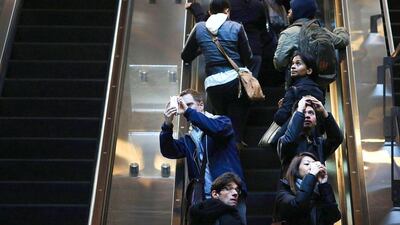 Commuters look up and photograph the newly opened Fulton Center. Spencer Platt / Getty Images / AFP